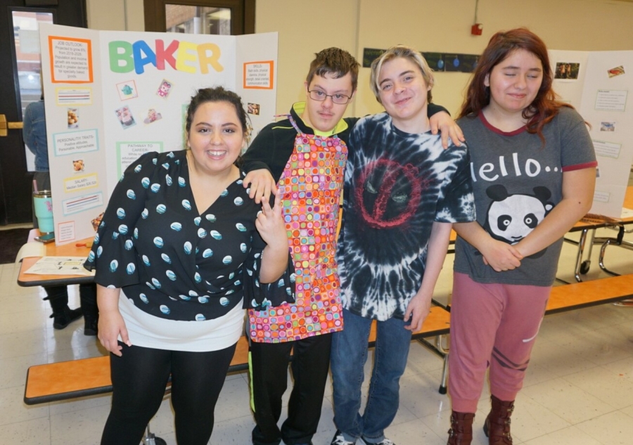 group of four students posing